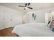 Bedroom featuring bright walls, wood-look floors, ceiling fan, and neutral decor for a serene space at 1420 W Ridge Rd, Littleton, CO 80120