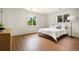 Bright bedroom with wood floors, white walls, modern platform bed, and natural light at 1420 W Ridge Rd, Littleton, CO 80120