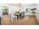 Bright dining room with modern light fixture, stylish decor, and hardwood floors at 1420 W Ridge Rd, Littleton, CO 80120