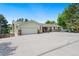 Charming home with a spacious driveway, stone accents, and a welcoming front porch at 1420 W Ridge Rd, Littleton, CO 80120
