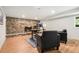Basement home office with decorative stone fireplace, desk, and black leather chairs at 1420 W Ridge Rd, Littleton, CO 80120
