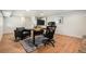 Basement home office with wood floors, desk, chair, and leather seating area at 1420 W Ridge Rd, Littleton, CO 80120