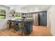 Kitchen with stainless steel appliances, ample cabinetry, an island and barstool seating at 1420 W Ridge Rd, Littleton, CO 80120