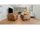 Cozy living room with stone fireplace, comfortable seating, and hardwood floors at 1420 W Ridge Rd, Littleton, CO 80120