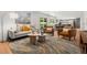Open concept living room with eat-in kitchen, large window, and comfortable seating at 1420 W Ridge Rd, Littleton, CO 80120