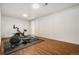 Basement workout room with wood floors, exercise equipment, and large closet at 1420 W Ridge Rd, Littleton, CO 80120