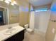 Clean bathroom with a combination bathtub and shower, modern vanity, and neutral tile at 11983 W Long Cir # 203, Littleton, CO 80127
