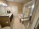 Bathroom showcasing tile flooring, glass shower, and bathtub at 11983 W Long Cir # 203, Littleton, CO 80127