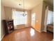 Sunny dining room with hardwood floors, a modern chandelier, and large windows with elegant curtains at 11983 W Long Cir # 203, Littleton, CO 80127