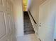 Bright entryway with tile flooring, a coat closet, and a carpeted staircase leading to the upper level at 11983 W Long Cir # 203, Littleton, CO 80127