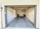Spacious two-car garage with exposed drywall and concrete flooring, ready for storage and vehicles at 11983 W Long Cir # 203, Littleton, CO 80127