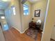 Well-lit upstairs hallway with hardwood floors, a built-in desk, and a large window for natural light at 11983 W Long Cir # 203, Littleton, CO 80127