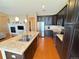 Modern kitchen with stainless steel appliances, granite countertops, a center island, and hardwood flooring at 11983 W Long Cir # 203, Littleton, CO 80127