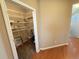 Large walk-in closet featuring multiple shelves, carpeted flooring, and ample storage space at 11983 W Long Cir # 203, Littleton, CO 80127