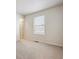 Bright bedroom features neutral carpet, a window with blinds, and white trim at 1448 Orchard St, Brighton, CO 80601