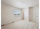 Bright bedroom features neutral carpet, a window with blinds, and white trim at 1448 Orchard St, Brighton, CO 80601