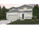 Two-story home with gray shingles, white siding, stone accents, manicured lawn, and an attached two-car garage at 1448 Orchard St, Brighton, CO 80601