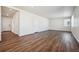 Spacious, naturally lit living room with dark wood floors and white walls, offering a versatile living space at 1448 Orchard St, Brighton, CO 80601