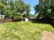Spacious, grassy backyard featuring a shed and wood fence at 6484 S Datura St, Littleton, CO 80120