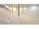 Spacious basement with neutral carpet and stairs to the upper level at 6484 S Datura St, Littleton, CO 80120