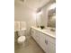 Bathroom with double vanity, modern lighting, and tiled floors at 6484 S Datura St, Littleton, CO 80120