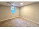 Cozy carpeted bedroom featuring a window and neutral paint at 6484 S Datura St, Littleton, CO 80120