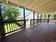 Deck with wood railing, with a view of the backyard and detached garage at 6484 S Datura St, Littleton, CO 80120