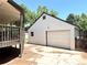Exterior view of the detached garage, deck, and side yard at 6484 S Datura St, Littleton, CO 80120