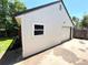 Side view of the detached garage with a white overhead door and side window at 6484 S Datura St, Littleton, CO 80120