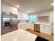 Modern kitchen featuring stainless steel appliances, ample counter space, and white cabinetry at 6484 S Datura St, Littleton, CO 80120
