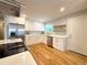 Bright kitchen featuring white cabinets, stainless steel appliances, and hardwood flooring at 6484 S Datura St, Littleton, CO 80120
