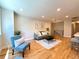 Cozy living room with hardwood floors, a comfortable sofa, and natural light at 6484 S Datura St, Littleton, CO 80120