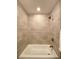 Shower-tub combo with light tiling and modern fixtures at 6484 S Datura St, Littleton, CO 80120