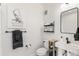 Modern bathroom featuring a sleek sink, toilet, decorative wall art, and stylish fixtures at 5367 W 14Th Ave, Lakewood, CO 80214