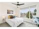 Bright bedroom featuring a large window with neighborhood views and a modern ceiling fan at 5367 W 14Th Ave, Lakewood, CO 80214