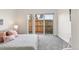 Bedroom with sliding glass doors to the fenced yard, offering natural light and privacy at 5367 W 14Th Ave, Lakewood, CO 80214