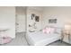 This cozy bedroom features a plush gray carpet, soft pink accents, and artful wall decor at 5367 W 14Th Ave, Lakewood, CO 80214