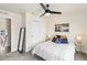 Cozy bedroom featuring a striped bedspread, modern ceiling fan, and large closet at 5367 W 14Th Ave, Lakewood, CO 80214