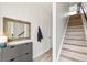 Bright hallway with wood stairs, decor mirror, coat rack, and built-in storage cabinet at 5367 W 14Th Ave, Lakewood, CO 80214