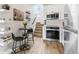 Contemporary kitchen with stainless steel appliances, white cabinets and a bar style dining area at 5367 W 14Th Ave, Lakewood, CO 80214