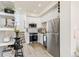 Modern kitchen with white cabinets, stainless steel appliances and breakfast nook with bar stools at 5367 W 14Th Ave, Lakewood, CO 80214