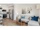 Bright living room featuring hardwood floors, white walls and decor, and an open layout into the kitchen at 5367 W 14Th Ave, Lakewood, CO 80214