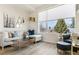 Light filled living room features hardwood floors, a large window, and comfortable seating at 5367 W 14Th Ave, Lakewood, CO 80214