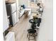 Spacious living area merges with a modern kitchen, creating an airy ambiance, enhanced by sleek lines, and contemporary accents at 5367 W 14Th Ave, Lakewood, CO 80214