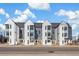 Modern townhomes in a row, with neutral paint and tasteful landscaping at 5367 W 14Th Ave, Lakewood, CO 80214