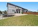 Green backyard with a concrete patio and trampoline, creating a perfect space for outdoor enjoyment at 13644 Ulster St, Thornton, CO 80602