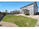 Expansive backyard featuring a well-maintained lawn, patio, and fenced perimeter, ideal for outdoor activities at 13644 Ulster St, Thornton, CO 80602