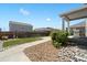Landscaped backyard with a concrete walkway leading to a covered patio that is perfect for relaxing at 13644 Ulster St, Thornton, CO 80602