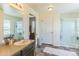 The beautiful bathroom features a modern vanity, an enclosed glass shower and a tiled floor at 13644 Ulster St, Thornton, CO 80602