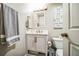 Bright bathroom featuring a vanity with stylish fixtures, decorative towels, and a charming accent sign at 13644 Ulster St, Thornton, CO 80602